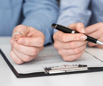 Close up Couple Signing Divorce Contract